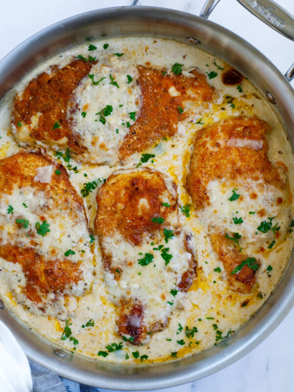 Caesar chicken in a creamy sauce in a skillet.