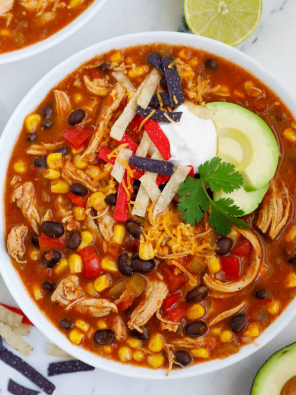 A top down photo of a bowl of chicken enchilada soup.