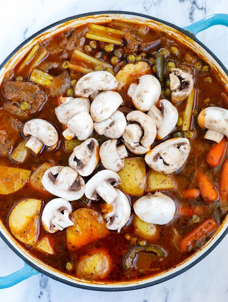 Vegetables and beef in a pot.