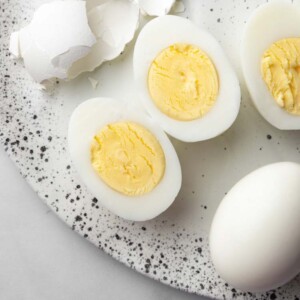 a hard boiled egg sliced in the middle showing the yolk.