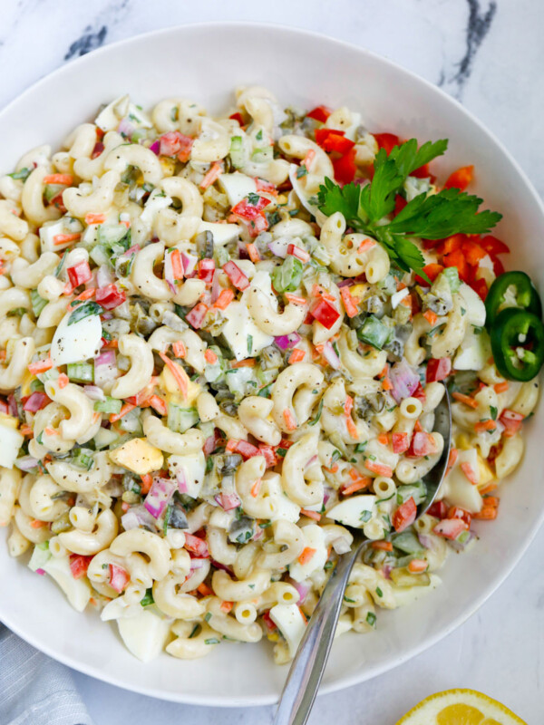 macaroni salad served in a bowl with a spoon