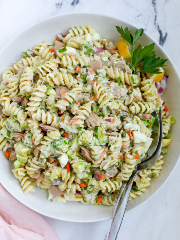 tuna pasta salad top down view with spoons inserted in the salad