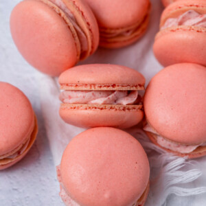 Close up of French macarons with strawberry cream filling.