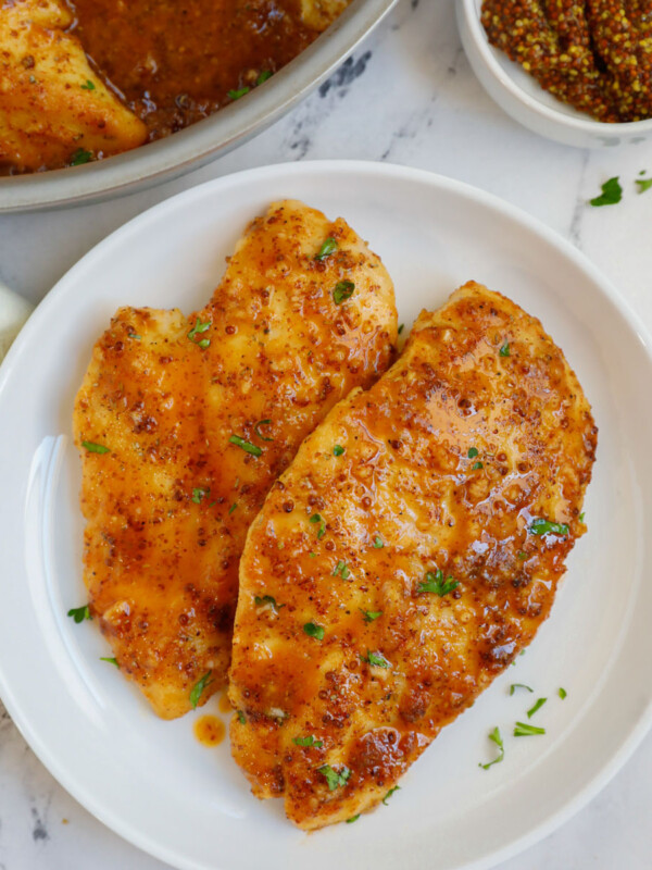 A plate of chicken with honey mustard sauce.