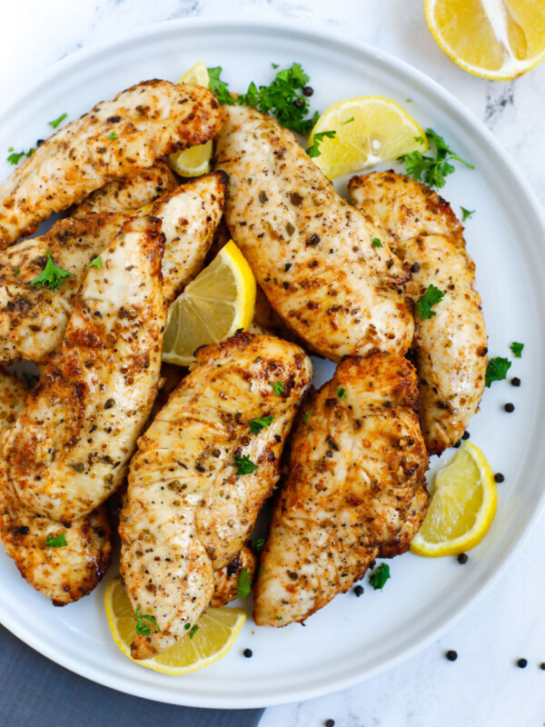 Top down view of lemon pepper chicken on a plate.