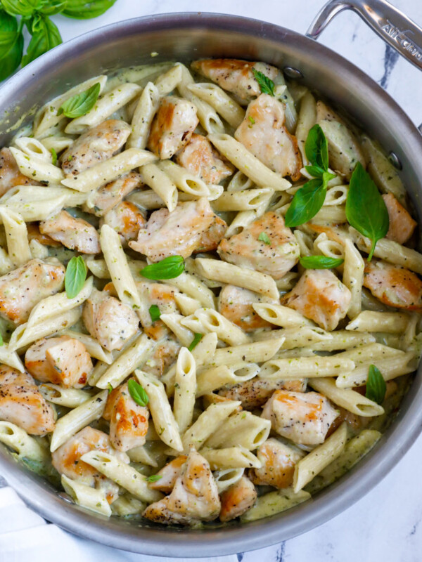 Creamy pesto chicken pasta in a pan.