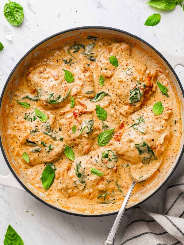 top down view of the creamy chicken thighs dish, garnished with basil leaves