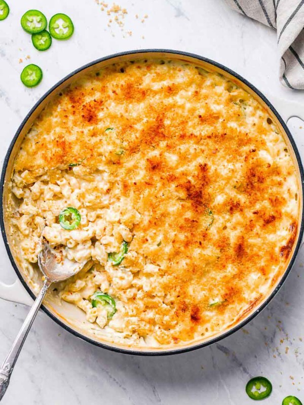 top down shot of mac in a skillet with a spoon in the skillet