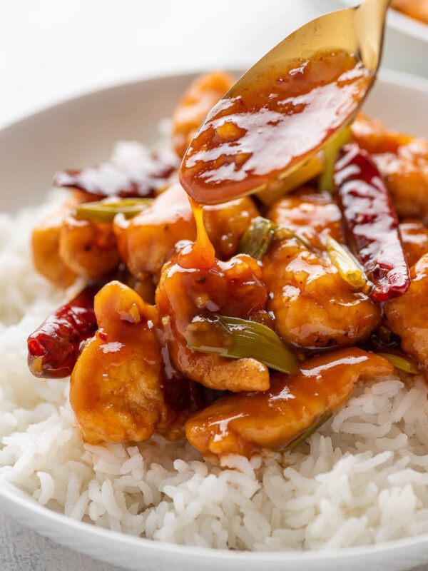 mongolian sauce being poured onto the chicken