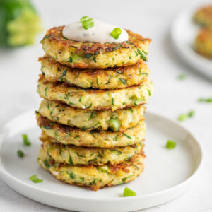 several zucchini fritters stacked on top of each other