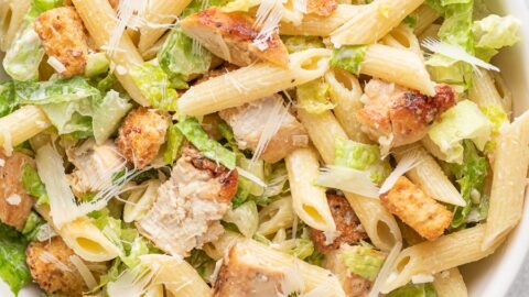 chicken ceasar pasta salad in a white bowl