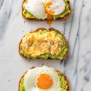 3 avocado toasts topped with fried, scrambled and pouched egg.