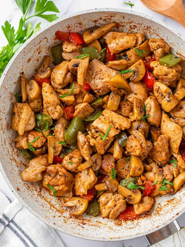 garlic butter chicken in a white skillet.