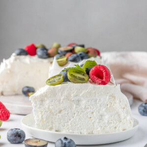 slice of berry pavlova cake on a white plate