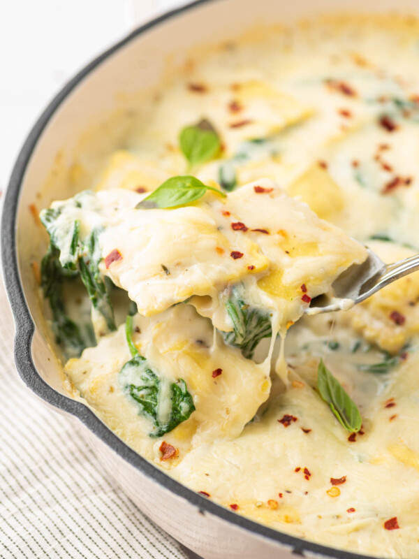 Cheese and Spinach Ravioli Recipe with a scoop being served.