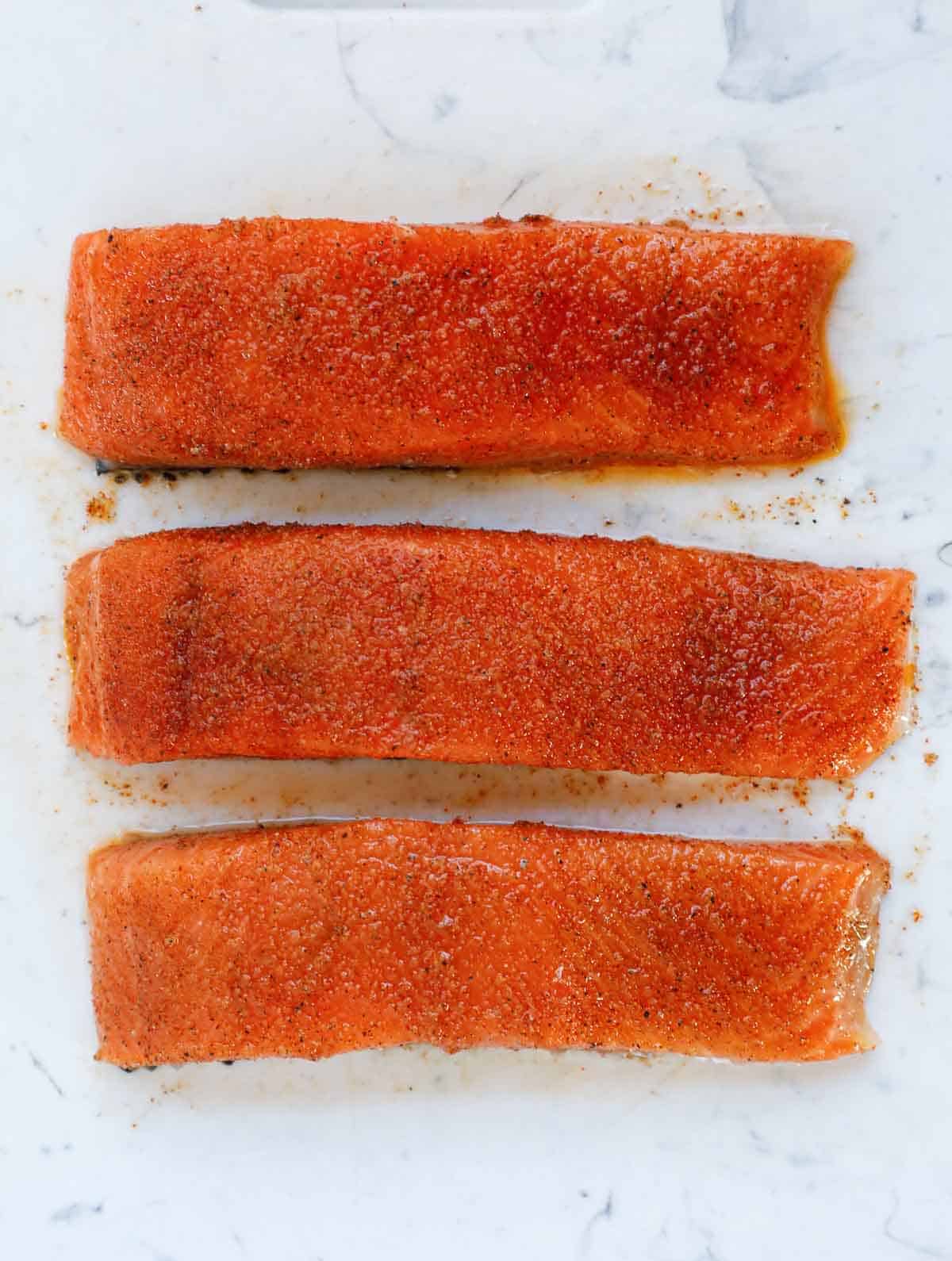 marinated salmon on a cutting board.