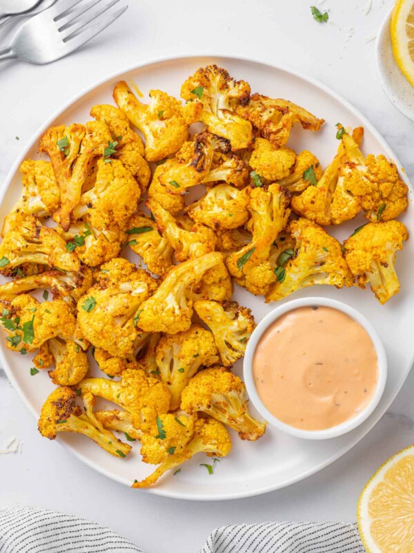 Cauliflower bites on a tray with dip.