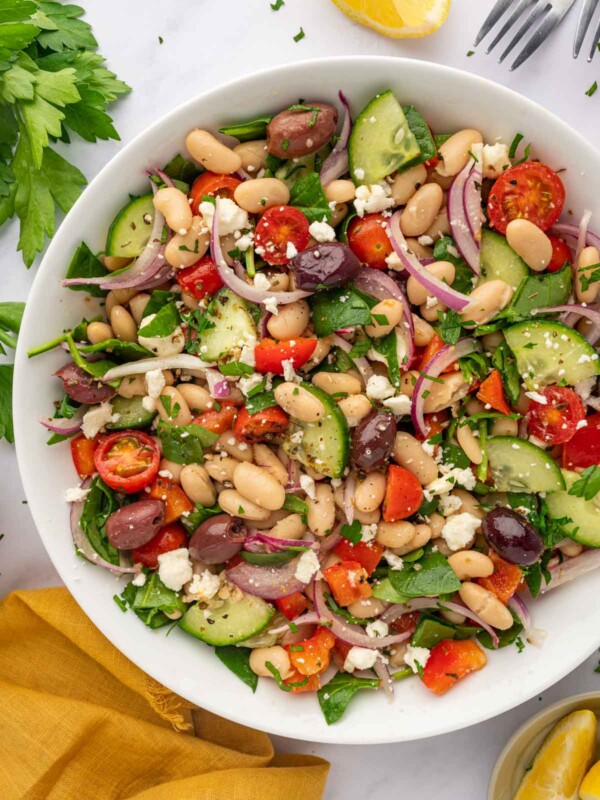 A large bowl of salad with beans and veggies.
