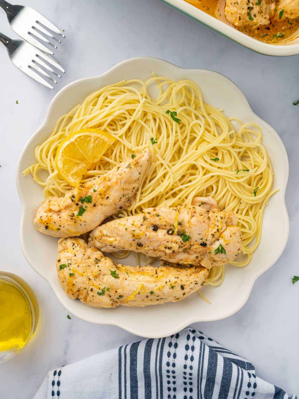 Lemon pepper chicken with pasta on a plate.