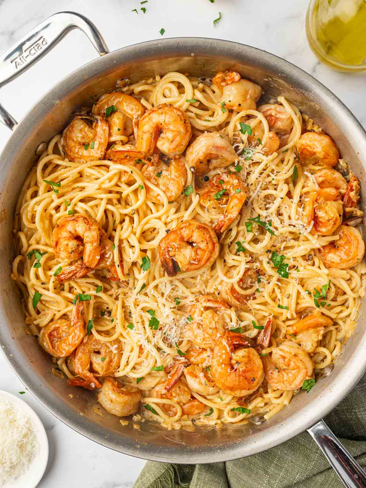 A skillet with spaghetti and spicy shrimp.