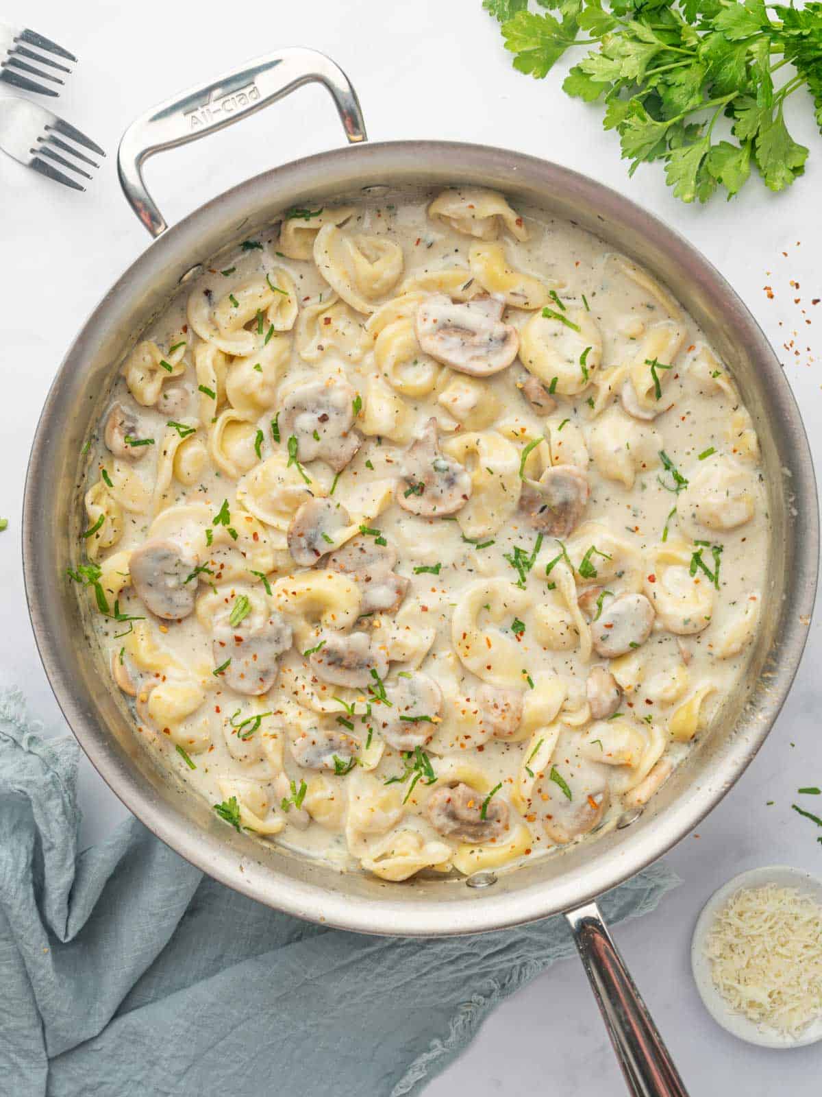 Cheese Tortellini Alfredo in a skillet.