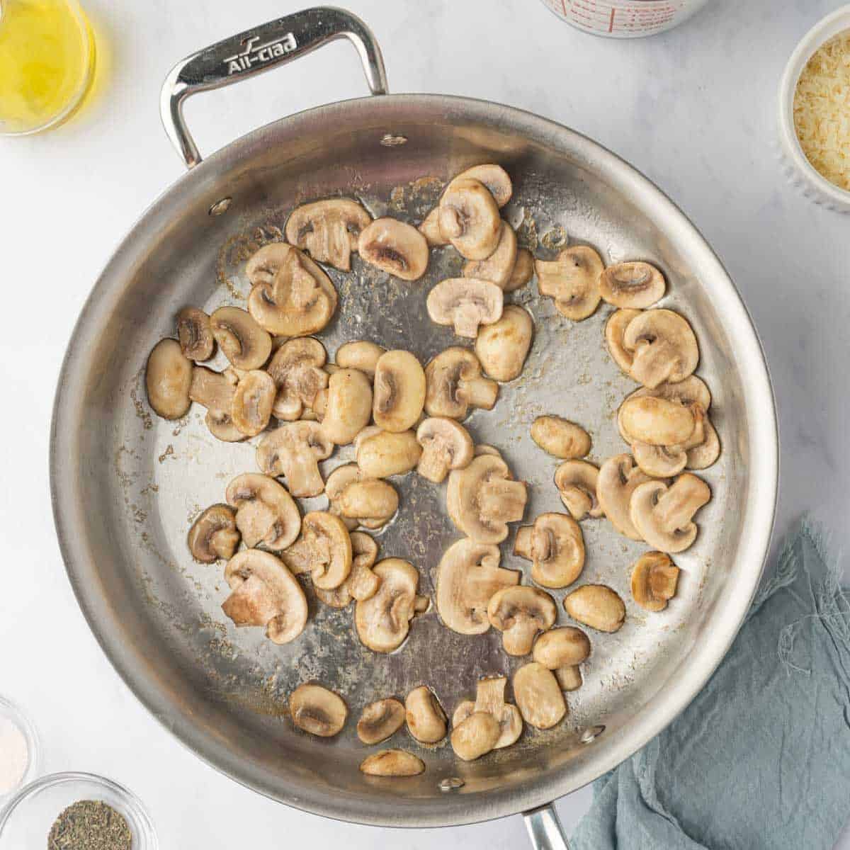 Mushrooms are sauteed in a skillet.