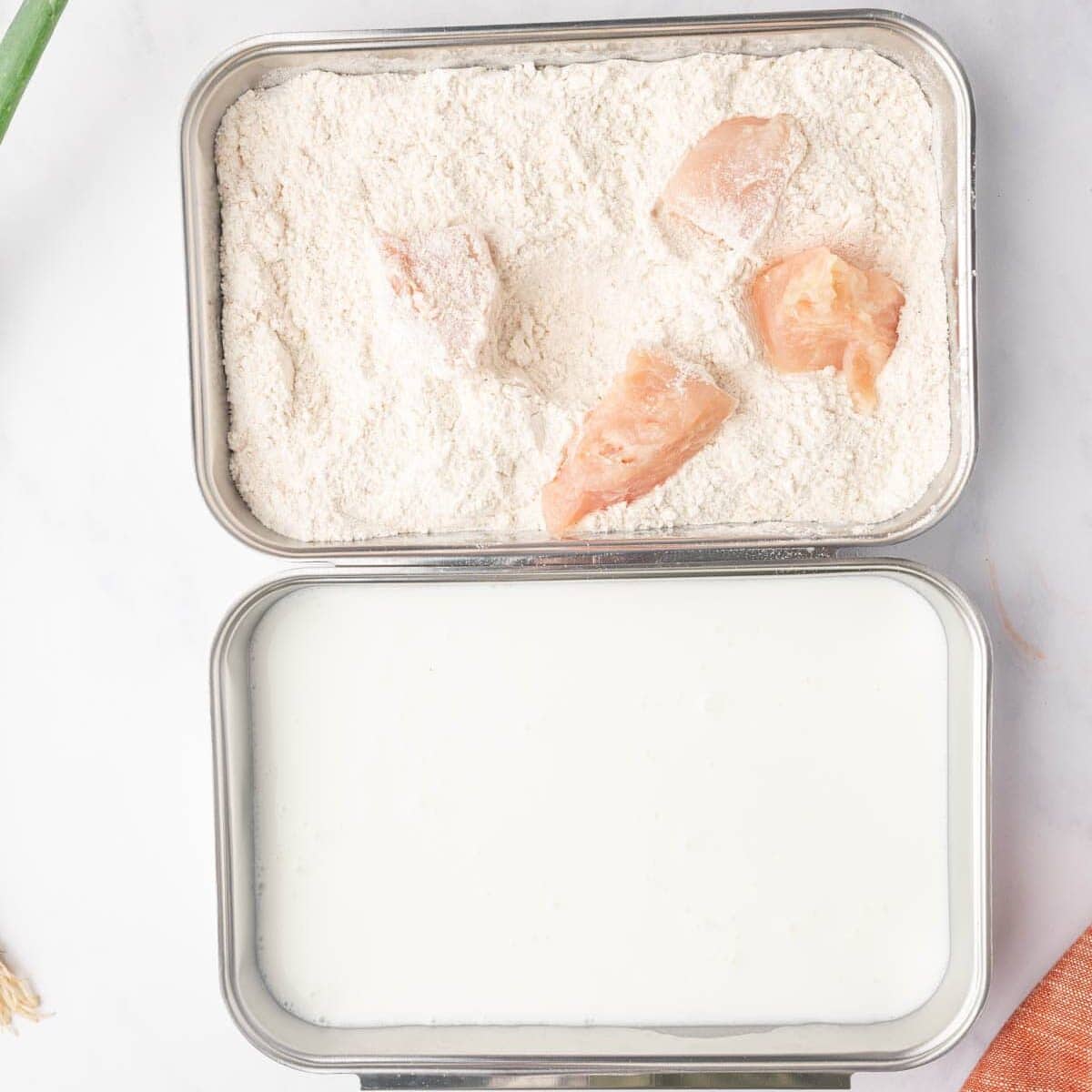 Process of dredging the chicken in buttermilk and flour mixtures.