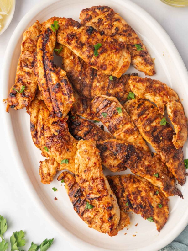Grilled peri peri chicken on a platter.