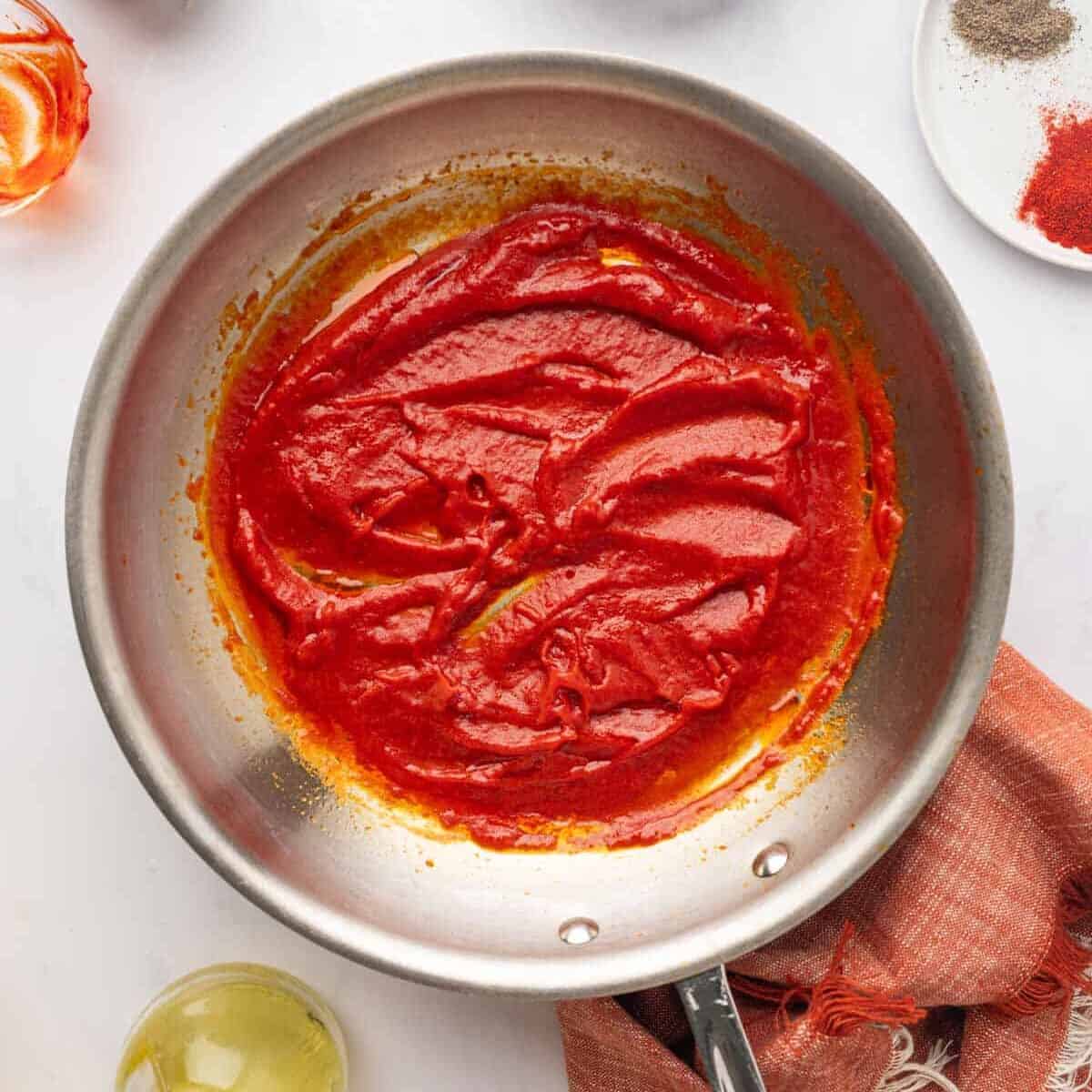 Tomato paste mixture cooked in a pan.