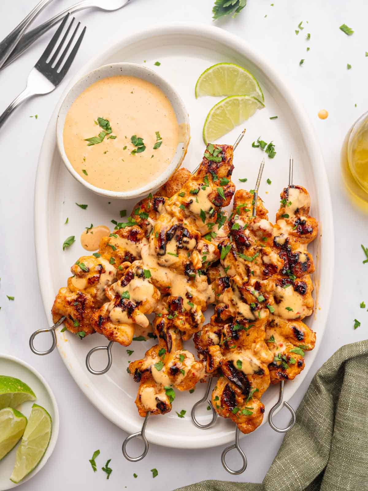 Bang bang chicken skewers on a platter.