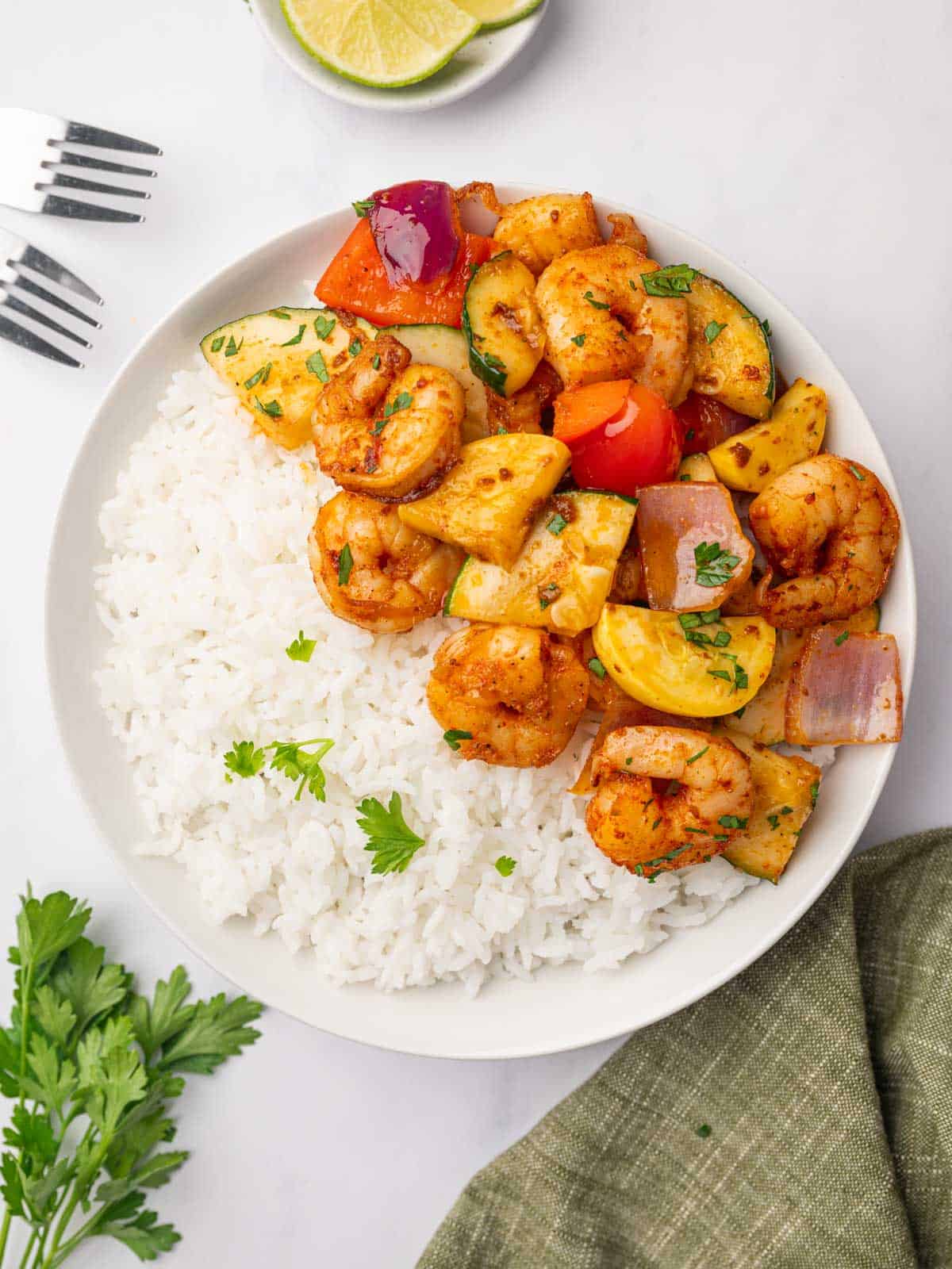 Shrimp and vegetable skillet meal served over white rice.