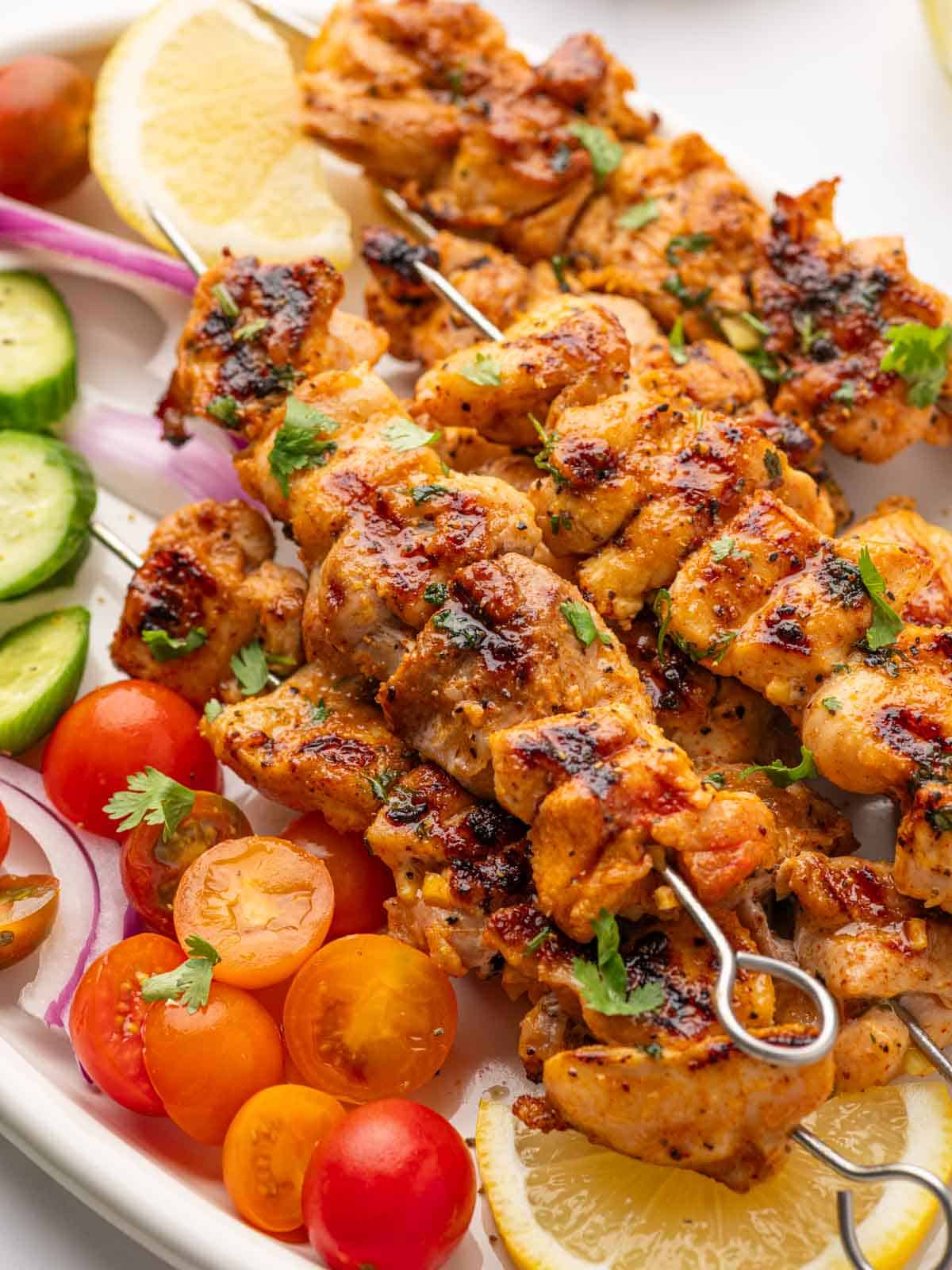 Close up of lemon pepper chicken thighs on a platter.