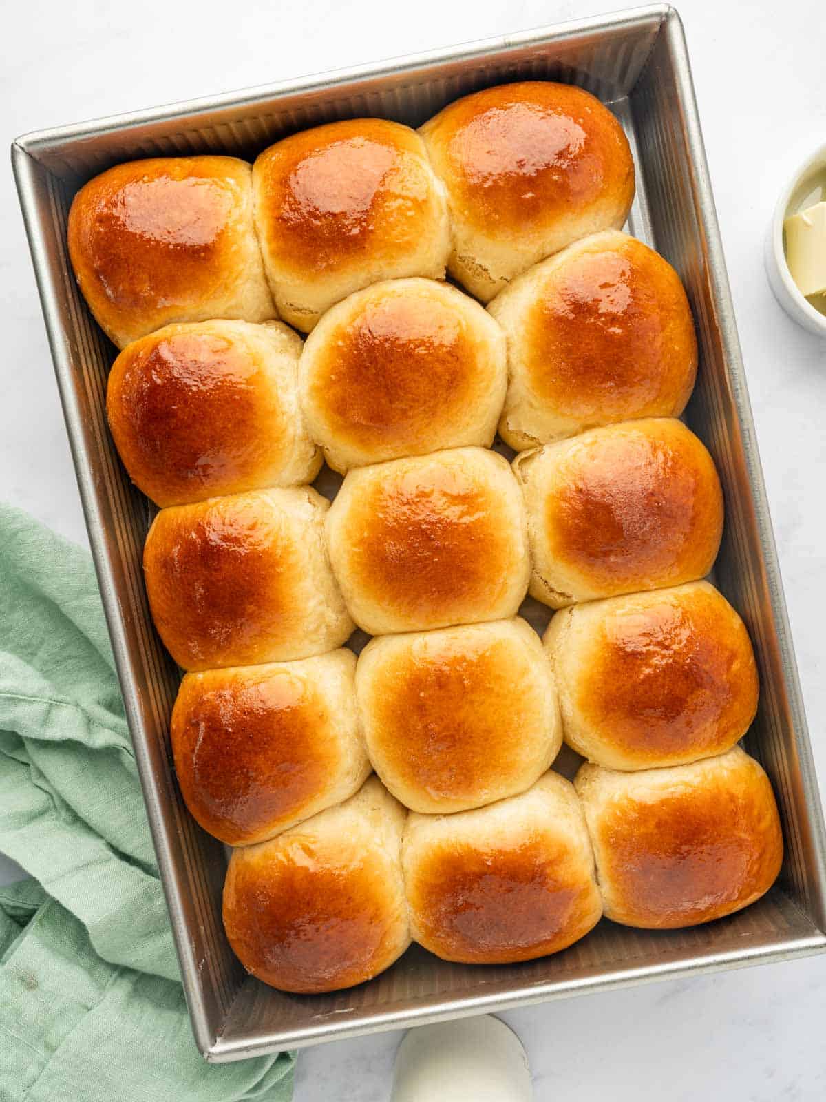 Top down shot of baked hawaiian sweet rolls.