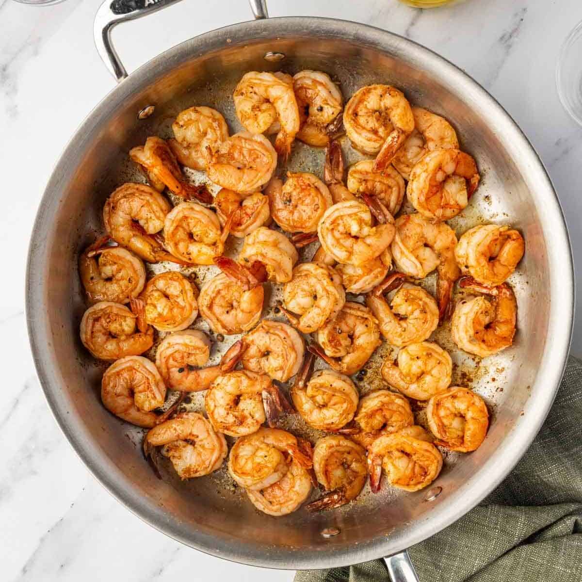 Saute shrimp in a skillet with cajun seasoning.