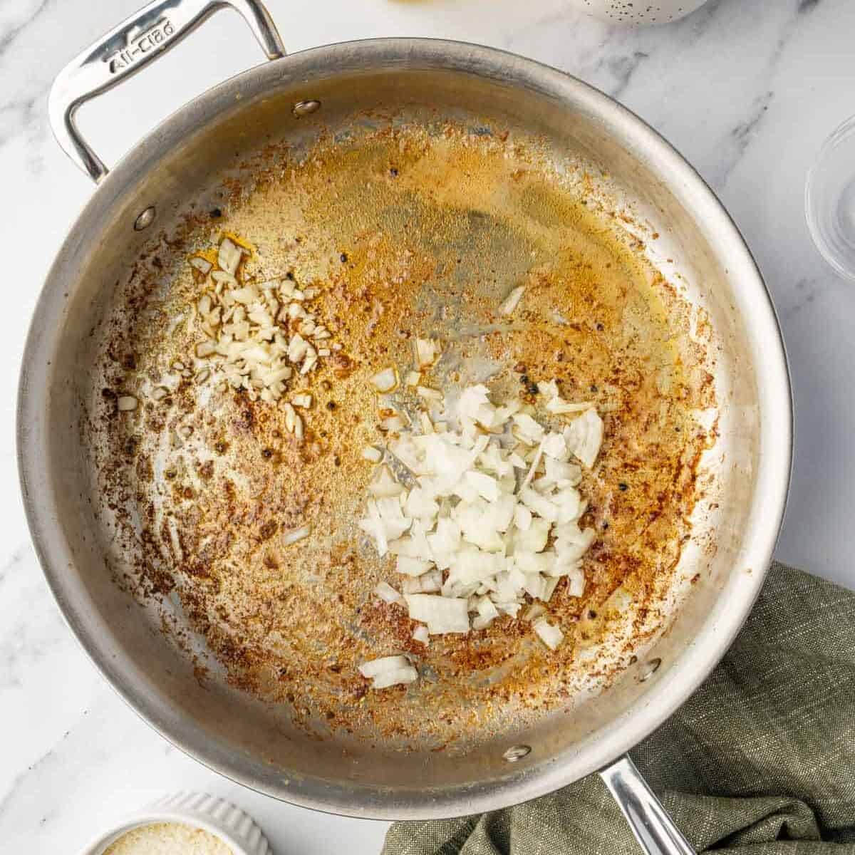 Saute onions and garlic in a skillet.