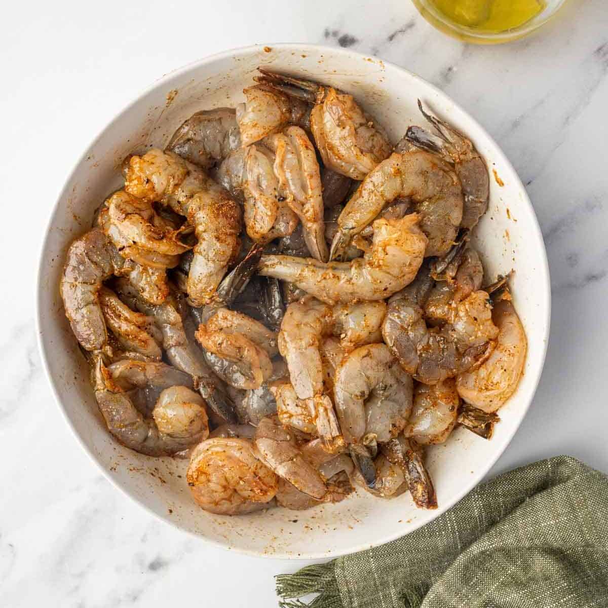 Marinated cajun shrimp in a bowl.